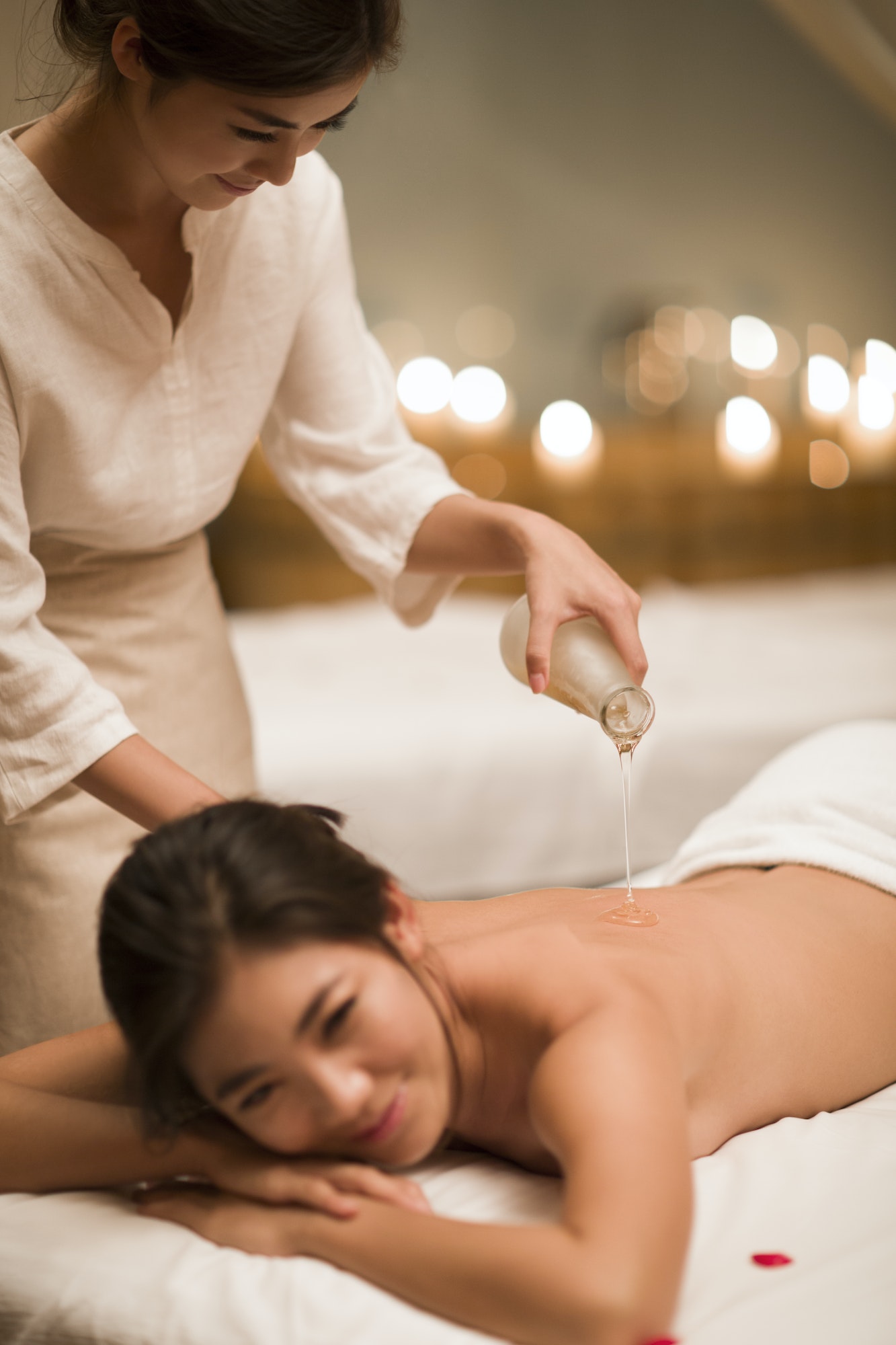 Young woman receiving back massage at spa center